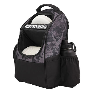 Side view of a grey and black camoflague pattern Discmania Fanatic Fly disc golf backpack that is open.