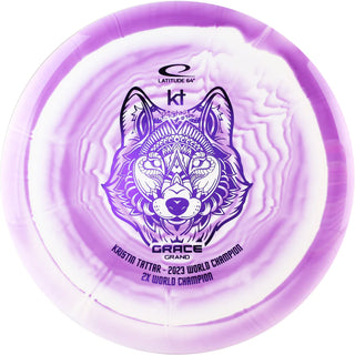 A purple and white Grand Orbit Grace disc golf disc.