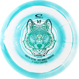 A turquoise and white Grand Orbit Grace disc golf disc.