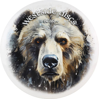 A white Tournament Bear disc golf disc with a bear face stamped on it.
