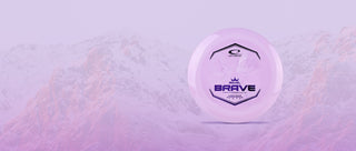 A discgolf disc presented on a background filled with snowy mountains