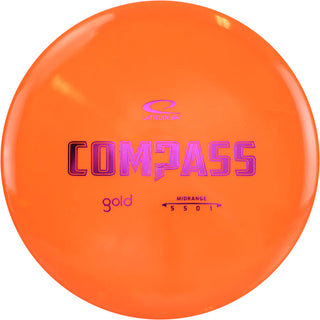 An orange Gold Compass disc golf disc.