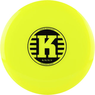 A yellow K1 Kaxe Retooled disc golf disc.