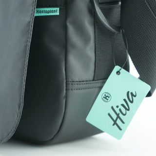 A close up view of the product tag on a black disc golf shoulder bag.