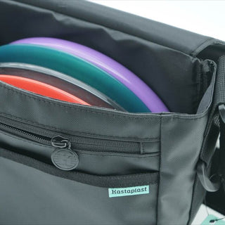 A close up view of an open disc golf shoulder bag containing four discs.