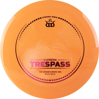 An orange Supreme Trespass disc golf disc.